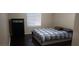 Cozy bedroom with a comfortable bed, dark floors, and window with blinds at 857 Lantham Pl, Las Vegas, NV 89110