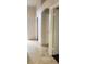 Neutral hallway featuring tile flooring, neutral paint, arched doorways, and recessed lighting at 857 Lantham Pl, Las Vegas, NV 89110
