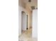 Hallway featuring tile flooring, neutral paint, and arched doorways at 857 Lantham Pl, Las Vegas, NV 89110