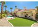 Beautiful backyard with pool, green turf area, and a spiral staircase to the second level at 8838 Spanish Mountain Dr, Las Vegas, NV 89148