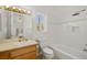 Well-lit bathroom featuring a shower-tub combo, toilet, and marble topped vanity with stylish fixtures at 8838 Spanish Mountain Dr, Las Vegas, NV 89148