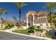 Impressive facade featuring mature palm trees, manicured landscaping, and a grand entrance at 8838 Spanish Mountain Dr, Las Vegas, NV 89148