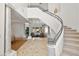 Elegant foyer with a curved staircase and marble flooring at 8838 Spanish Mountain Dr, Las Vegas, NV 89148