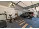 The well-lit garage has epoxy floors, storage cabinets, and space for cars and a home gym at 8838 Spanish Mountain Dr, Las Vegas, NV 89148