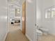 Hallway featuring a powder room and leading to the main bedroom, enhancing privacy and convenience at 8838 Spanish Mountain Dr, Las Vegas, NV 89148