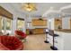 Kitchen with breakfast bar and tile floors adjoins a cozy sitting area at 8838 Spanish Mountain Dr, Las Vegas, NV 89148