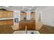 Spacious kitchen boasts a large island with gas range, granite counters, and wood cabinetry at 8838 Spanish Mountain Dr, Las Vegas, NV 89148