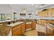 Bright kitchen features granite countertops, wood cabinets, tile floor, and stainless steel appliances at 8838 Spanish Mountain Dr, Las Vegas, NV 89148