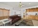 Comfortable living space with brown sofa, built-in bar, and views to the upper level at 8838 Spanish Mountain Dr, Las Vegas, NV 89148
