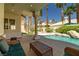 The backyard features a spiral staircase and a relaxing seating area that overlooks a beautiful blue pool at 8838 Spanish Mountain Dr, Las Vegas, NV 89148