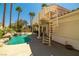 The home offers a backyard oasis complete with a gorgeous pool with rock features and a spiral staircase at 8838 Spanish Mountain Dr, Las Vegas, NV 89148