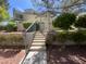 Welcoming entrance to property featuring manicured landscaping and stairs leading to the front door at 8940 Clairton Ct, Las Vegas, NV 89117