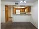 Galley kitchen with tile floors, cabinets, white appliances, and a breakfast bar at 8940 Clairton Ct, Las Vegas, NV 89117
