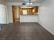 Galley kitchen with tile floors, cabinets, white appliances, and a breakfast bar at 8940 Clairton Ct, Las Vegas, NV 89117