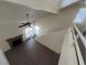 Living room features a fireplace, access to the outside, and open view from the loft at 8940 Clairton Ct, Las Vegas, NV 89117