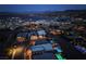 Night aerial view of a luxury community with pools and a lake backdrop at 9 Reverie Heights Ave, Henderson, NV 89011