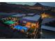 Night aerial view shows a luxury backyard oasis with a pool, spa, and outdoor seating area at 9 Reverie Heights Ave, Henderson, NV 89011