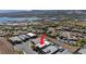 Beautiful desert home with a swimming pool, identified by a red arrow, in an upscale lakefront neighborhood at 9 Reverie Heights Ave, Henderson, NV 89011
