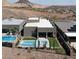 Aerial view of modern backyard with a pool, spa, and covered patio, surrounded by desert landscape at 9 Reverie Heights Ave, Henderson, NV 89011