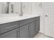 Modern bathroom featuring gray cabinetry, white countertops, and sleek hardware for a clean aesthetic at 9 Reverie Heights Ave, Henderson, NV 89011