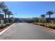 Gated community entrance lined with palm trees, offering privacy and security at 9 Reverie Heights Ave, Henderson, NV 89011