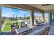 Inviting covered patio with comfortable seating, a view of the spa, and beautifully landscaped backyard at 9 Reverie Heights Ave, Henderson, NV 89011