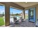 Relaxing covered patio with comfortable outdoor chairs, and a view of the pool, turf and desert landscape at 9 Reverie Heights Ave, Henderson, NV 89011