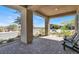 View of the cozy covered patio with two black outdoor chairs and desert landscape in the background at 9 Reverie Heights Ave, Henderson, NV 89011