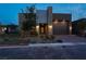 Elegant house featuring a garage with outdoor lighting and tasteful desert landscaping at twilight at 9 Reverie Heights Ave, Henderson, NV 89011