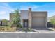Contemporary home showcasing a two-car garage, stone accents, and desert-friendly landscaping at 9 Reverie Heights Ave, Henderson, NV 89011