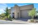 Well-maintained home with a two-car garage, xeriscaped front yard, and stone facade in a desert setting at 9 Reverie Heights Ave, Henderson, NV 89011