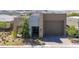 Charming single Gathering home with two-car garage, stone facade, modern stucco, and xeriscaped front yard at 9 Reverie Heights Ave, Henderson, NV 89011