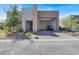Contemporary home featuring a spacious garage with an open door, stone accents, and desert landscaping at 9 Reverie Heights Ave, Henderson, NV 89011