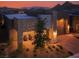 Modern home featuring a covered patio area with seating, a stone facade, and desert-friendly landscaping at 9 Reverie Heights Ave, Henderson, NV 89011