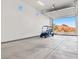 Spacious garage interior featuring a golf cart and scenic desert views through an open door at 9 Reverie Heights Ave, Henderson, NV 89011