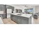 Modern kitchen with white countertops, gray cabinets, and seamless connection to dining and living areas at 9 Reverie Heights Ave, Henderson, NV 89011