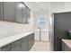 Well-lit laundry room with gray cabinets, a gray countertop and modern stainless-steel appliances at 9 Reverie Heights Ave, Henderson, NV 89011