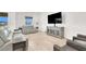 Bright living room is furnished with modern furniture and features backyard views at 9 Reverie Heights Ave, Henderson, NV 89011