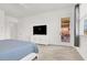 Spacious primary bedroom with plush carpeting, a ceiling fan, and access to an outdoor patio at 9 Reverie Heights Ave, Henderson, NV 89011