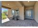 Charming covered patio with stone flooring, modern seating, and views of desert landscape at 9 Reverie Heights Ave, Henderson, NV 89011