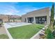 Lush backyard with a modern pool, spa, turfed yard, patio, and desert-friendly landscaping at 9 Reverie Heights Ave, Henderson, NV 89011