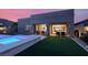 Exterior view featuring a modern pool, spa, covered patio, and manicured lawn at 9 Reverie Heights Ave, Henderson, NV 89011