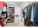 Bright walk-in closet featuring built-in shelves and rod system for clothes and shoe storage at 9 Reverie Heights Ave, Henderson, NV 89011
