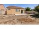 View of the home's backyard featuring a concrete patio, beige stucco and a red tile roof at 9001 Picket Fence Ave, Las Vegas, NV 89143