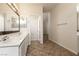 Bathroom featuring double sinks, neutral walls, tiled floors, and lots of natural light at 9001 Picket Fence Ave, Las Vegas, NV 89143