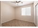 Bedroom with neutral walls, a ceiling fan and large window allowing natural light at 9001 Picket Fence Ave, Las Vegas, NV 89143
