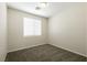 Bedroom with neutral walls, carpet, and a window letting in light at 9001 Picket Fence Ave, Las Vegas, NV 89143