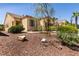 Inviting single-story home with desert landscaping, a two-car garage, and mature trees at 9001 Picket Fence Ave, Las Vegas, NV 89143