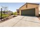 Spacious two-car garage and driveway, with desert landscaping at 9001 Picket Fence Ave, Las Vegas, NV 89143