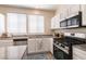 Bright kitchen with a gas range, stainless steel appliances, and modern fixtures at 9001 Picket Fence Ave, Las Vegas, NV 89143